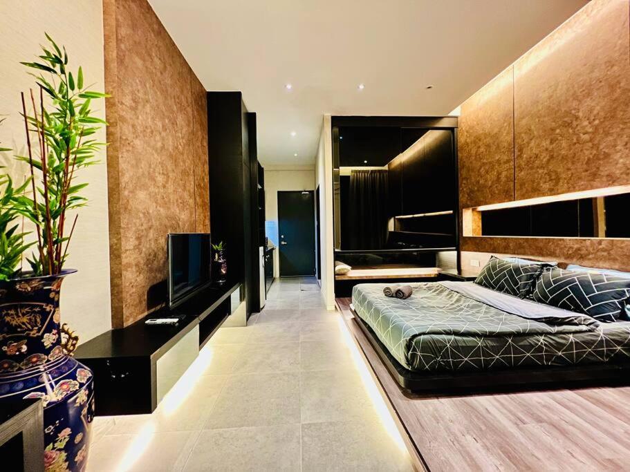 a bedroom with a bed and a tv in it at Montana Suites 3, Empire Damansara in Petaling Jaya