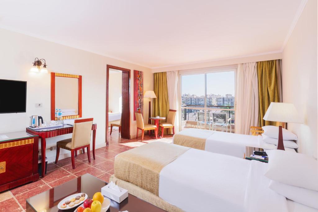 A bed or beds in a room at Coral Sea Beach and Aqua Park