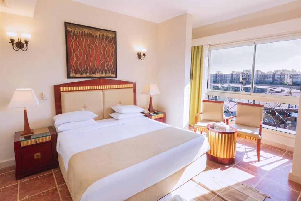 A bed or beds in a room at Coral Sea Beach and Aqua Park