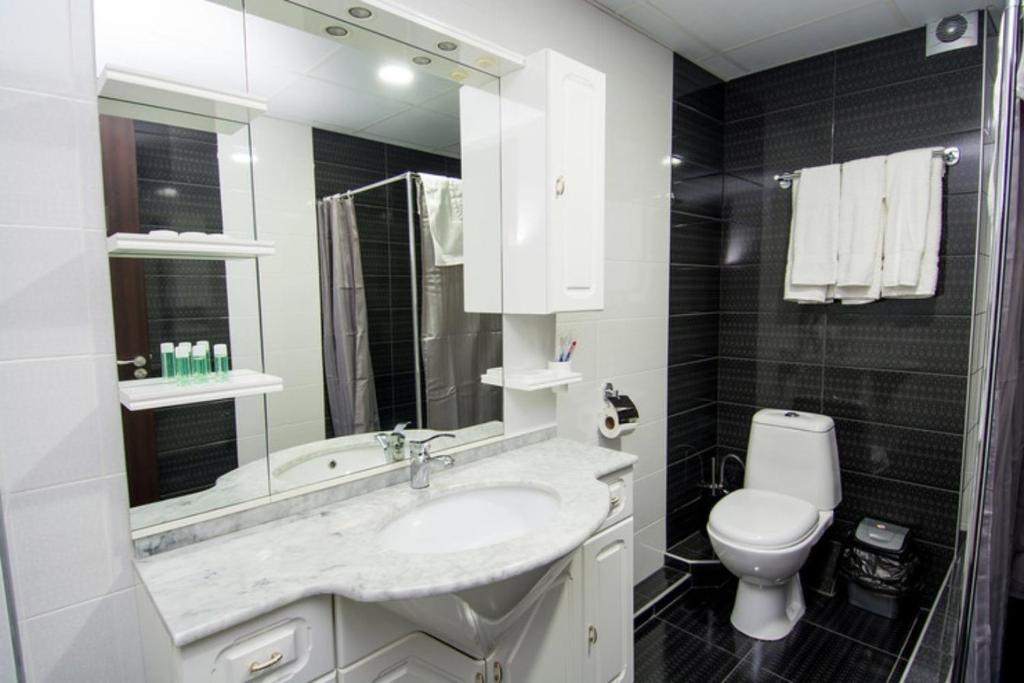 een witte badkamer met een wastafel en een toilet bij - Granada - Boutique Hotel - Tbilisi - in Tbilisi City