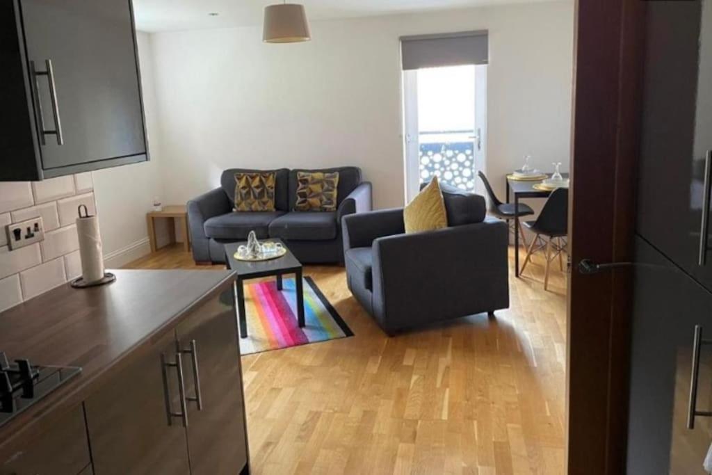 a living room with a couch and a table at HU1 Stylish Cozy Central Apartment WIFI H3 in Hull