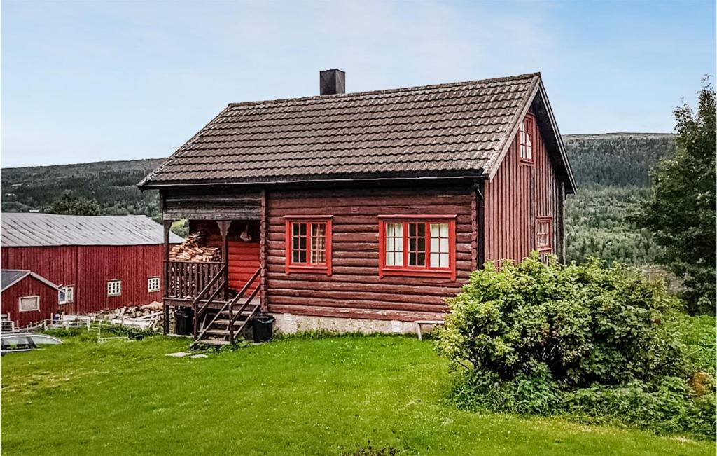 una casa de madera con un granero rojo en un campo en 2 Bedroom Stunning Home In len, en Ålen
