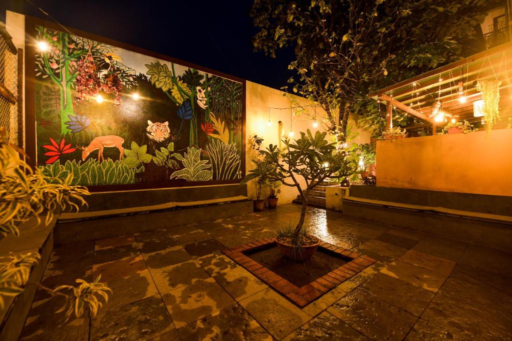 a building with a painting on the wall with plants at SAFARI QUEST in Mysore