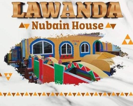 Lawanda Nubian House في أسوان: a sign that reads la ramella nubian house