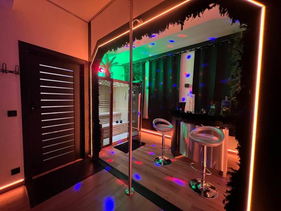 a bathroom with two stools in front of a mirror at Aux Secrets De Lora, Chambre de charme VIP in Verviers