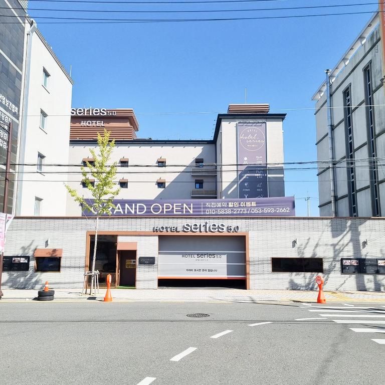 a large building with a sign for a store at Daegu Seongseo Hotel Series 5.0 in Daegu