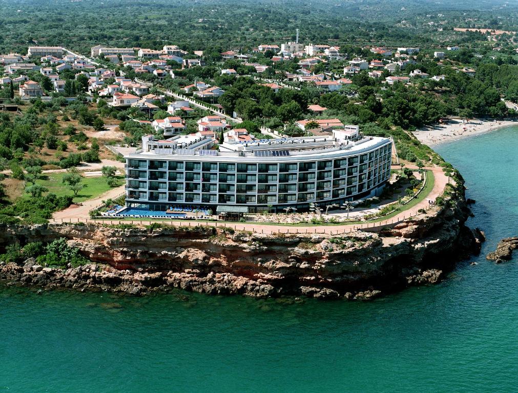 an aerial view of a hotel on a rocky island in the water at FERGUS Cap Roig in L'Ampolla