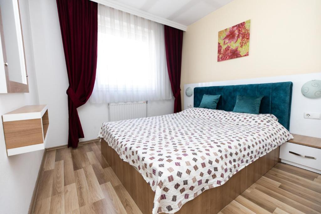 Postel nebo postele na pokoji v ubytování Dodona ApartHotel in Prishtina