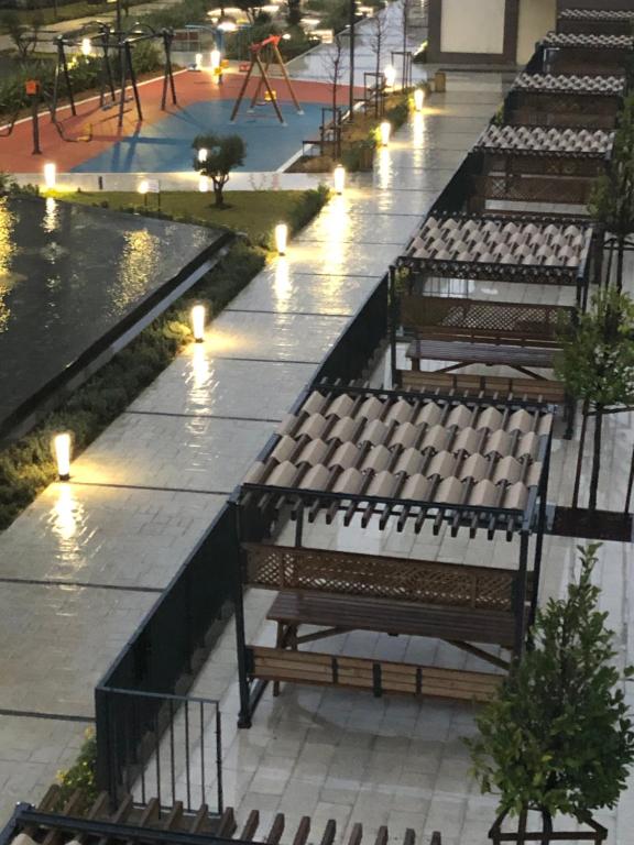 a row of benches in a park with lights at Lux 2+1 apartment in Başakşehir ISTANBUL in Basaksehir