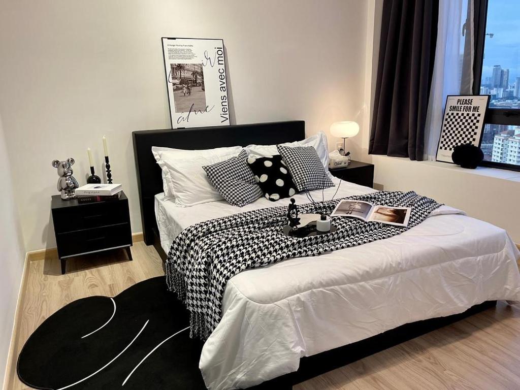 een slaapkamer met een bed met een zwart-witte deken bij 5 min Sunway Lagoon PJ KL Cosy Stylish Suite Big Pool in Petaling Jaya