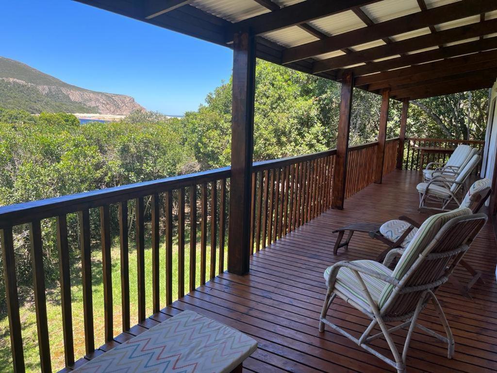 a porch with chairs and a view of the mountains at Lagoon View in Plettenberg Bay