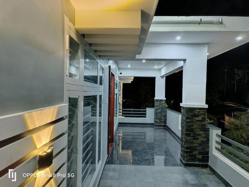 a hallway of a house with a walkway at Peppercorn Cottage, Vythiri. in Vythiri