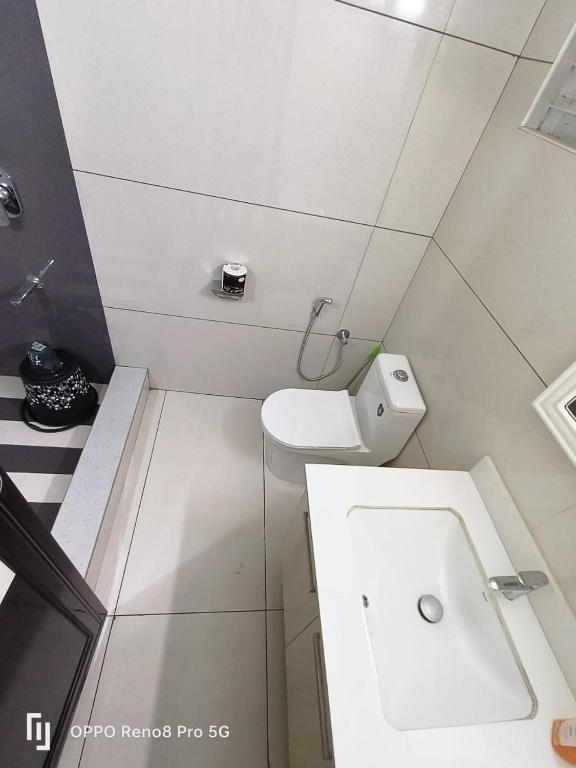a small bathroom with a toilet and a sink at Peppercorn Cottage, Vythiri. in Vythiri
