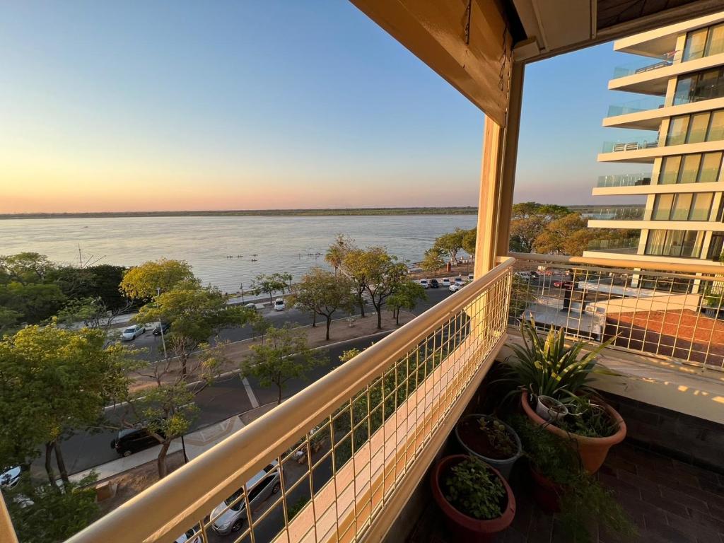 a balcony with a view of the water at Bitcoins House Costanera in Corrientes