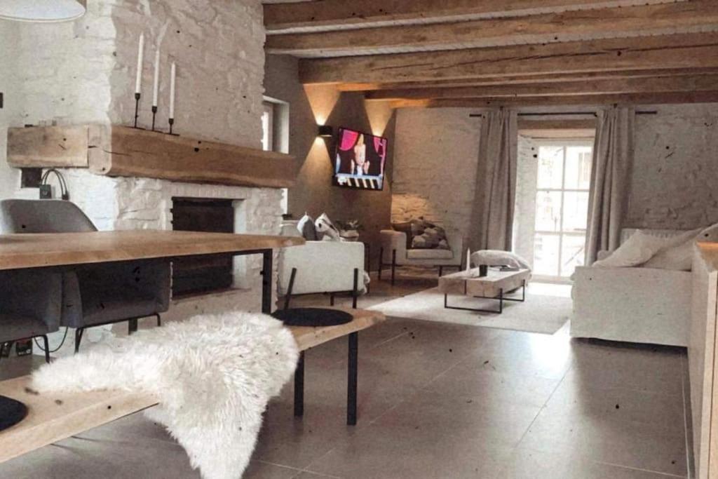 a living room with a couch and a fireplace at Charmante maison de vacances in Vaux-sur-Sûre