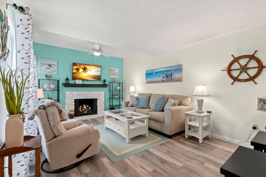 a living room with a couch and a fireplace at Madeira Beach Yacht Club 357H in St Pete Beach