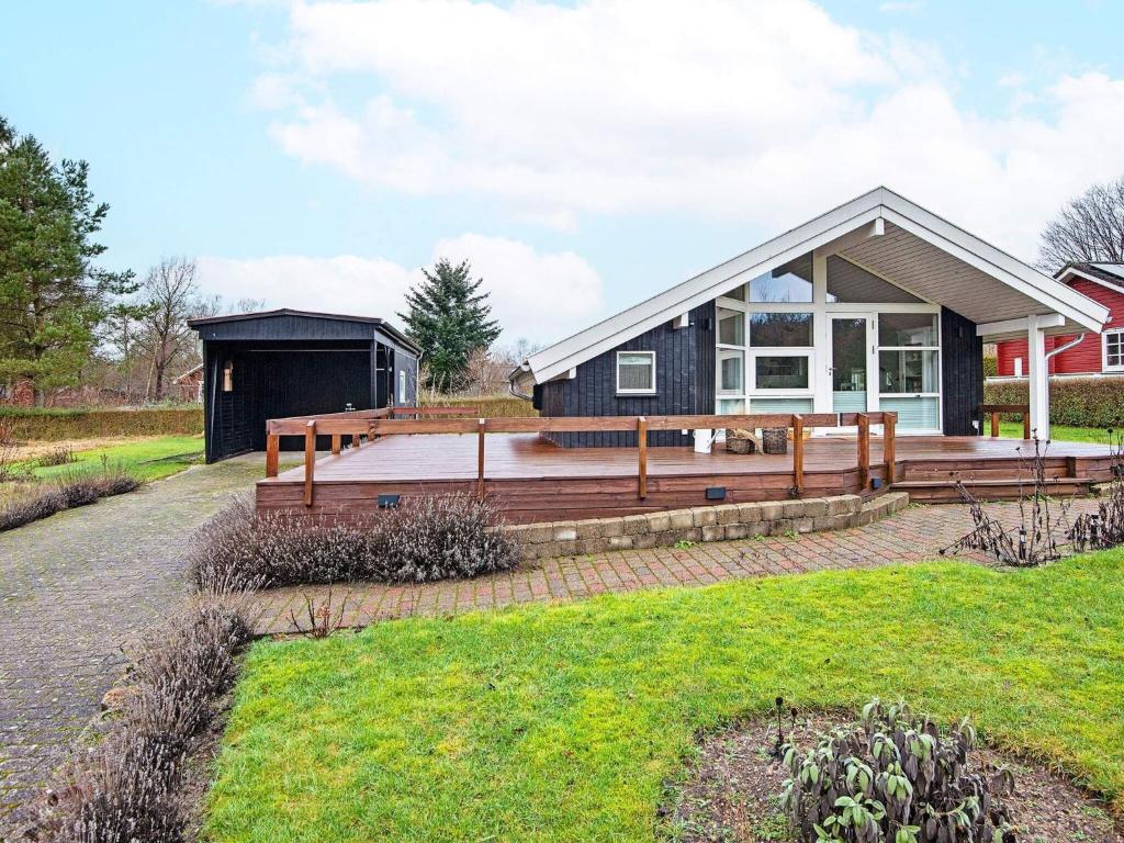 a home with a large deck and a house at Holiday home Silkeborg XXI in Silkeborg