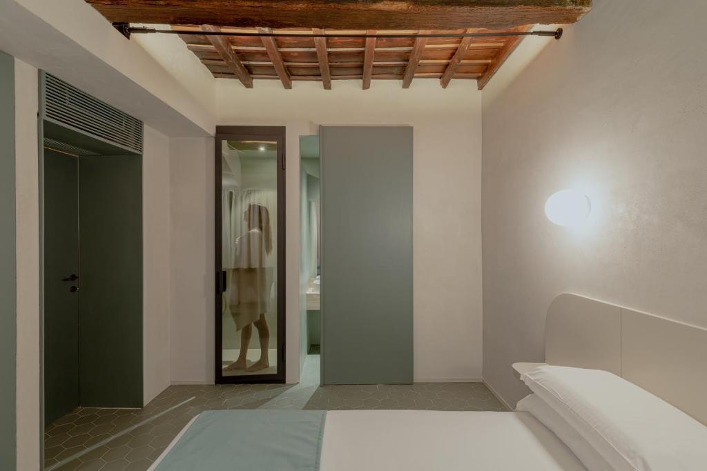 A bed or beds in a room at Design apartment with private pool in Campo dei Fiori