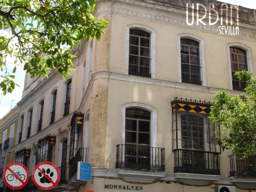 a building with a sign on the side of it at Hostel Urban Sevilla in Seville