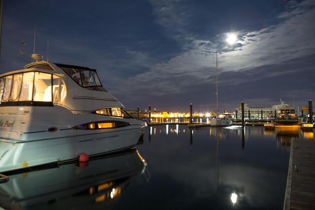 a boat docked in a marina at night at Sea Pearl Boston Yacht in Boston