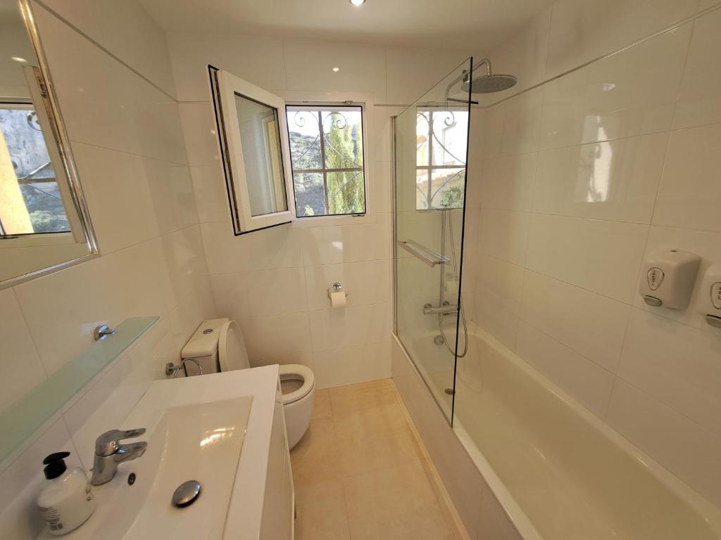 a bathroom with a shower and a sink and a toilet at la ventana al mar in Jávea