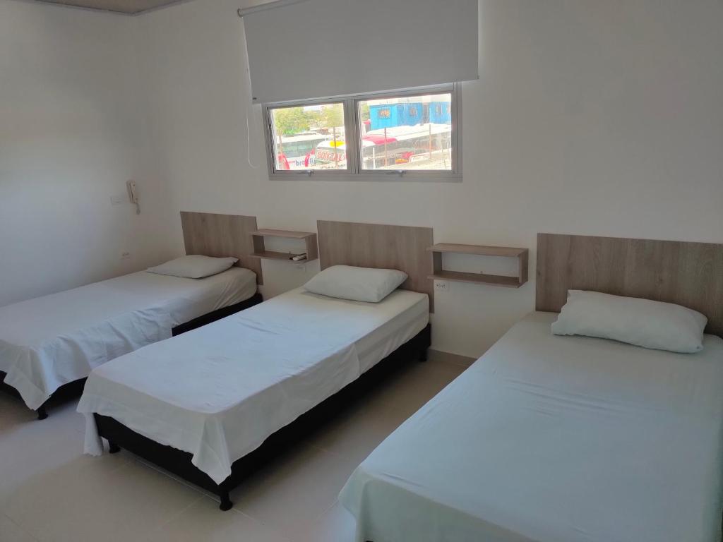 Ένα ή περισσότερα κρεβάτια σε δωμάτιο στο HOTEL MAR DEL CARIBE