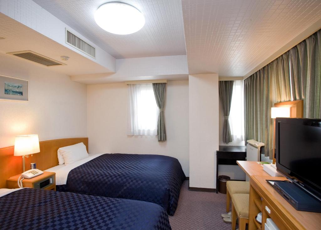 Postel nebo postele na pokoji v ubytování Matsue Urban Hotel