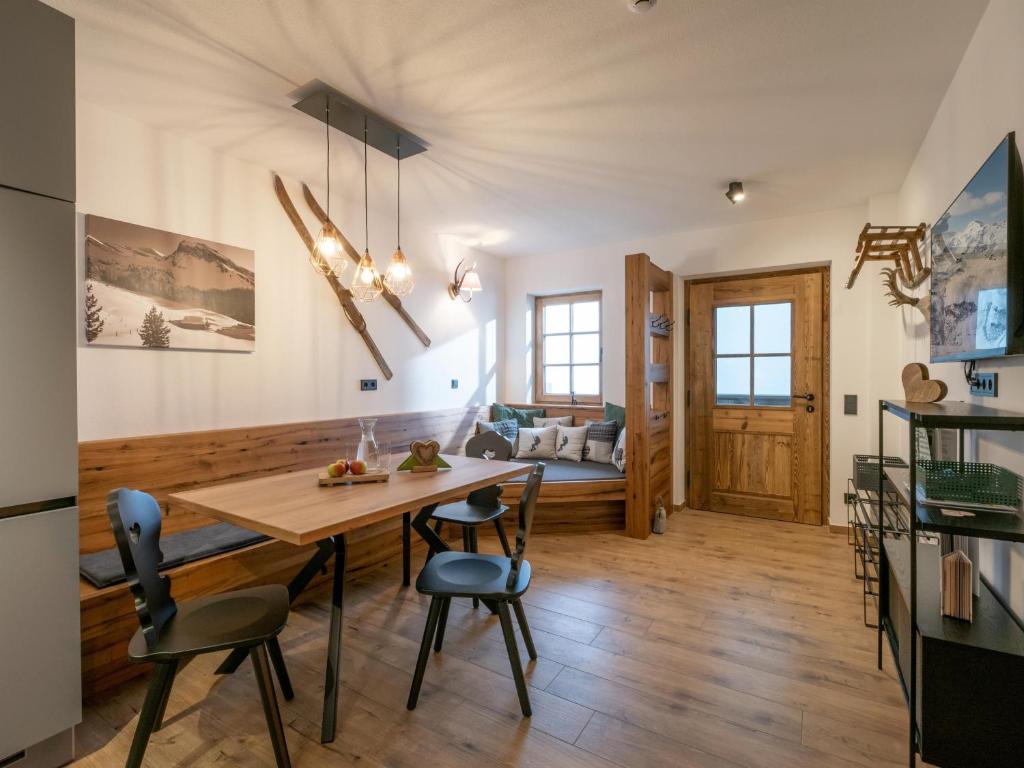 a kitchen and dining room with a table and chairs at Alpenliebe Zillertal in Hart im Zillertal