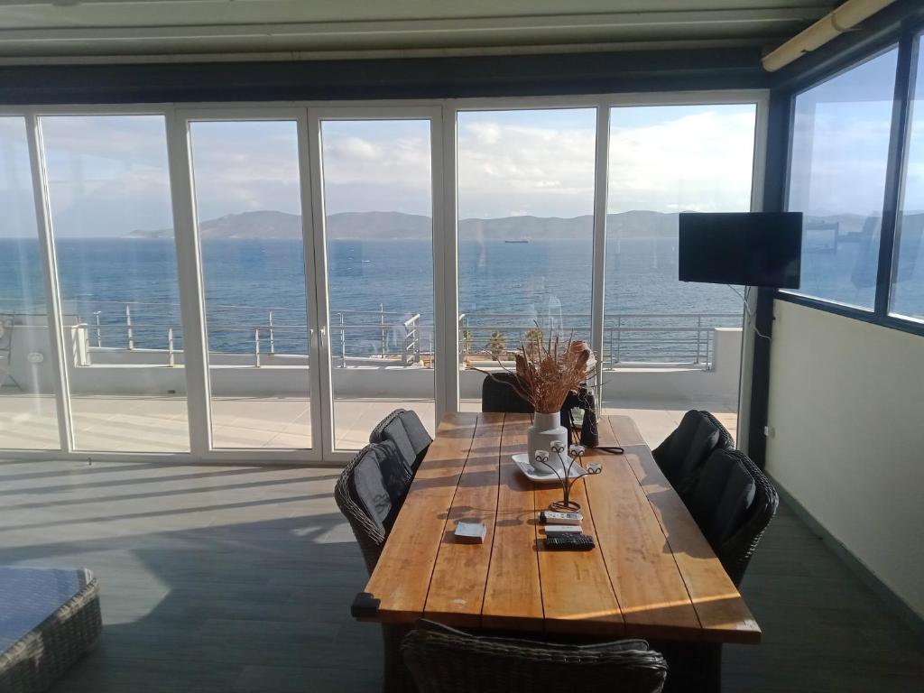 a dining room with a table and a view of the ocean at deep blue in Lávrion