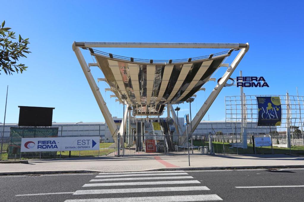 a large metal structure on the side of a street at Alla fiera di Roma in Ponte Galeria