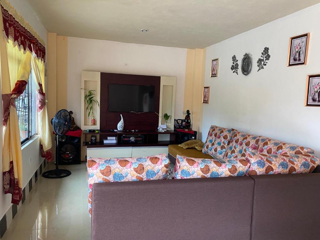 a living room with a couch and a flat screen tv at Casa en san Cristobal in Puerto Baquerizo Moreno