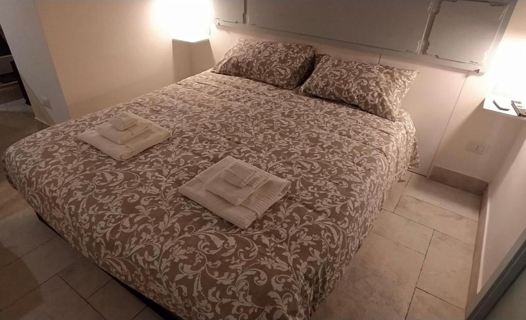 a bedroom with a bed with two pillows on it at La Mansio del Vicolo in Mola di Bari