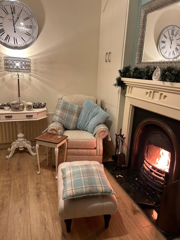a living room with a couch and a fireplace at TJ’s Cottage in Enniskillen