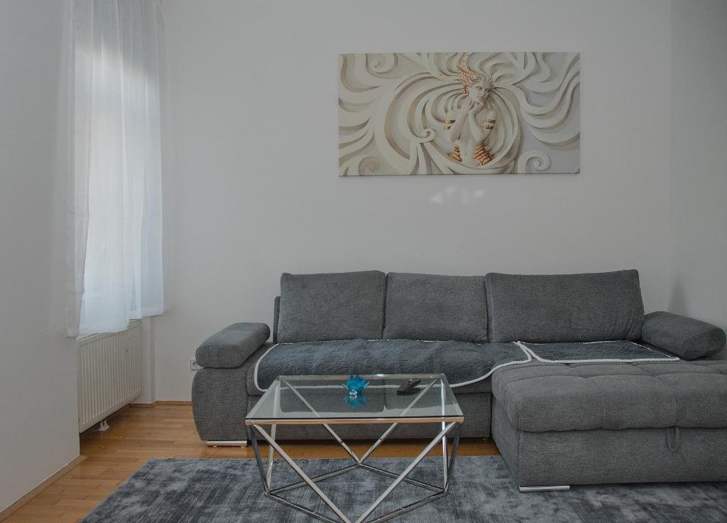 a living room with a couch and a table at Blue Lotus Apartment in Vienna