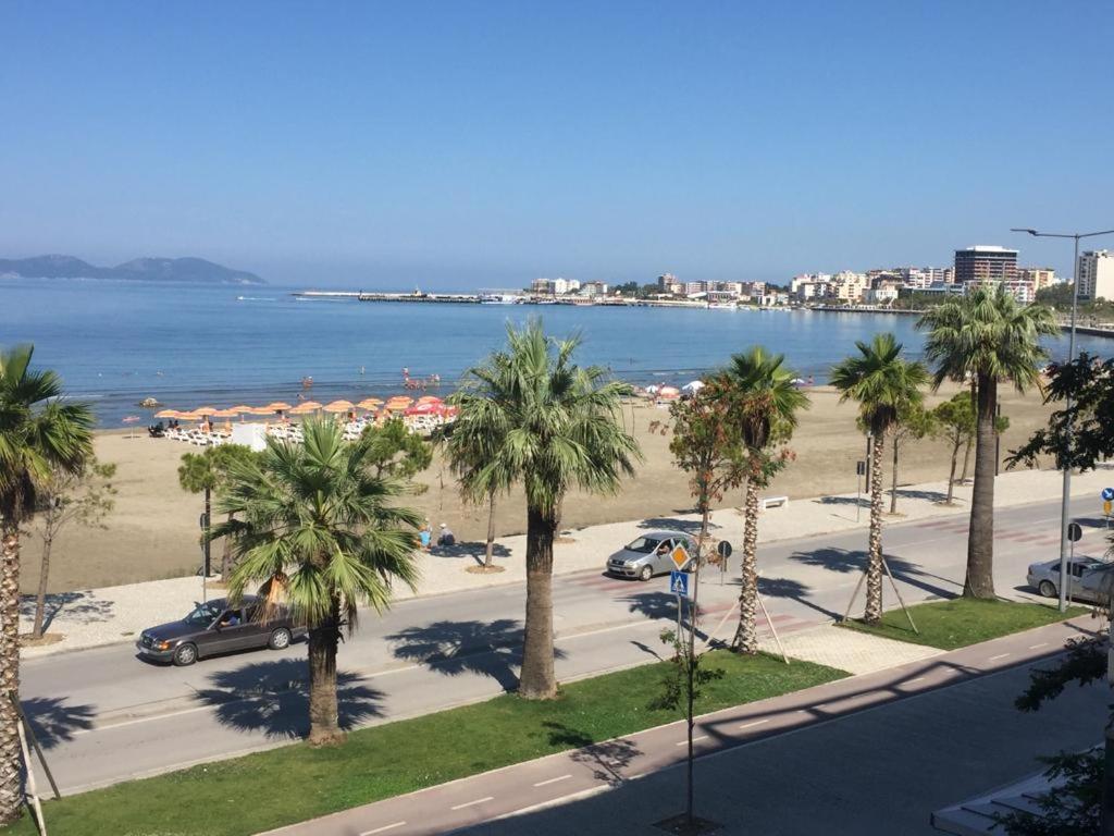 uma vista para um parque de estacionamento com palmeiras e a praia em DREAM APARTMENT Vlore em Vlorë