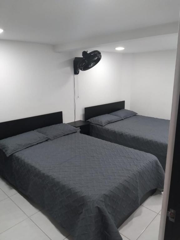 Postel nebo postele na pokoji v ubytování Hotel Murano Medellín