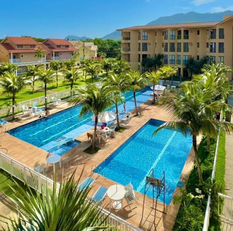 an image of a swimming pool at a resort at Loft Sahy - Condado Aldeia dos Reis in Mangaratiba