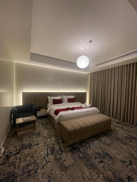 a bedroom with a bed and a couch and a chair at Golden New Quraish Jeddah in Jeddah