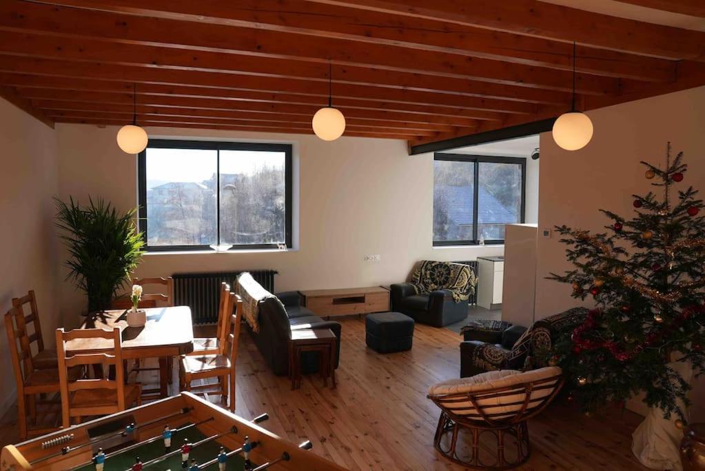 a living room with a christmas tree in the middle at Votre appartement à Chalmazel in Chalmazel