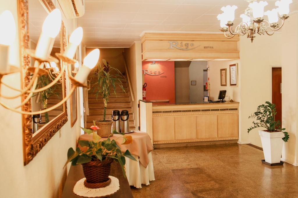 a lobby with a waiting area and a table with plants at Rigo Hotel in Santa Rosa