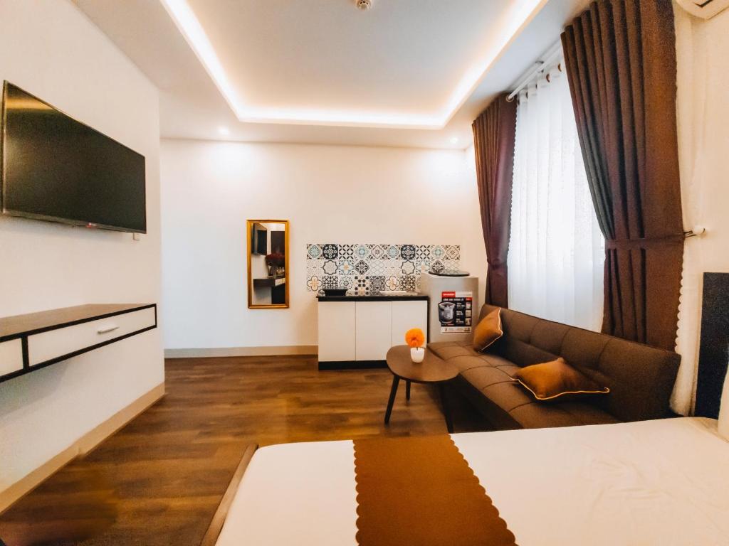 Postel nebo postele na pokoji v ubytování King Hotel Da Nang