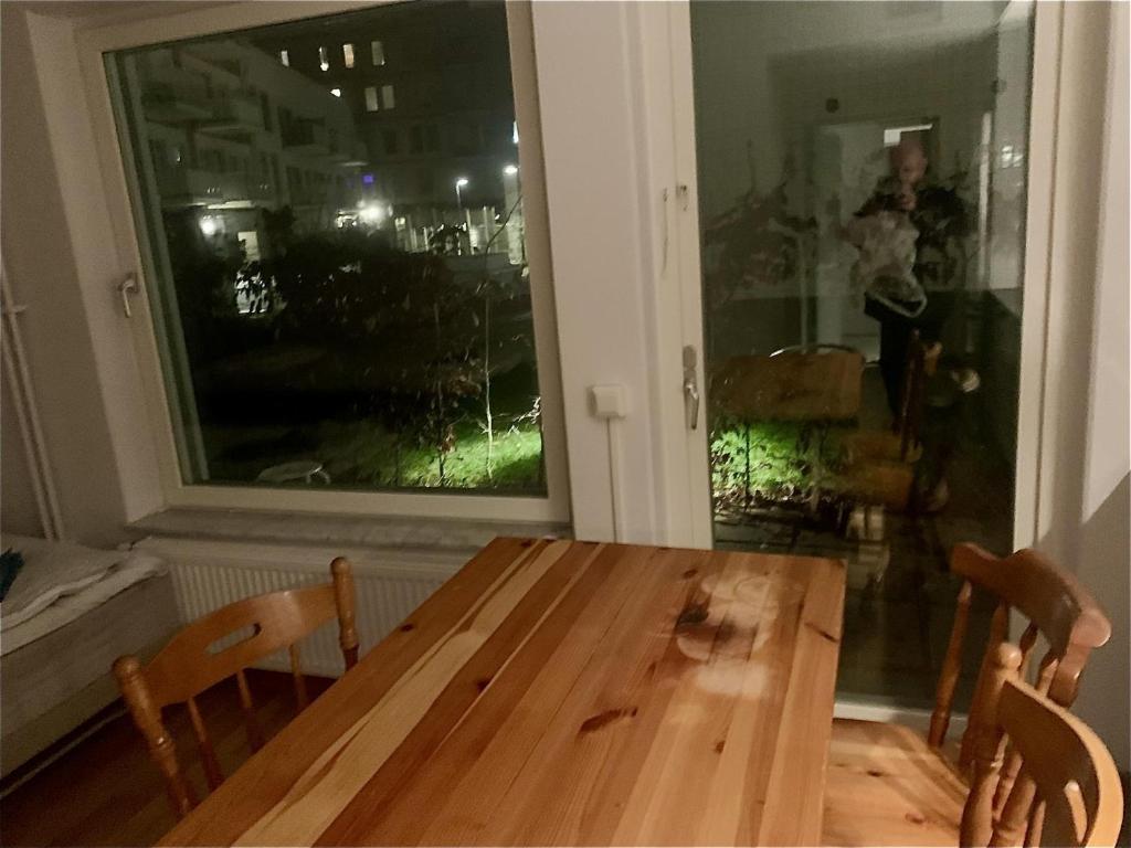 a wooden table and chairs in a room with a window at Two room Apartment in Sundbyberg Stockholm in Sundbyberg