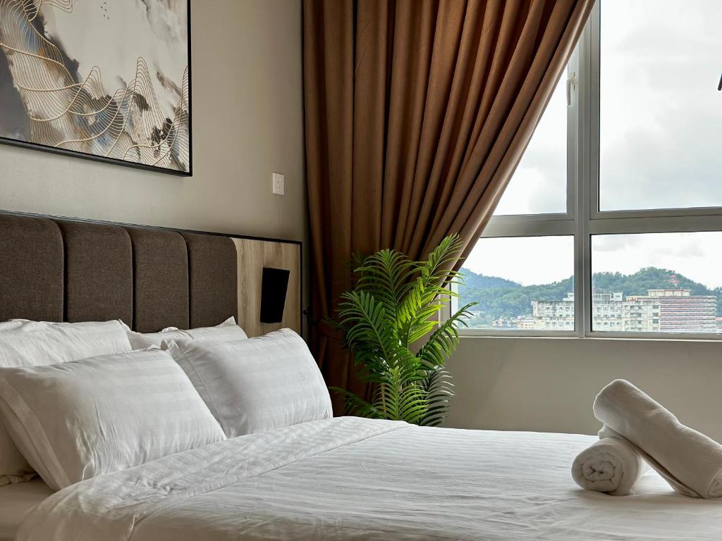 a bedroom with a bed with a large window at CiptaRase Apartment - Drawbridge,KTCC mall, Kuala Terengganu in Kuala Terengganu