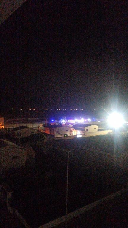 a parking lot at night with a street light at Island Hostel in Alexandria