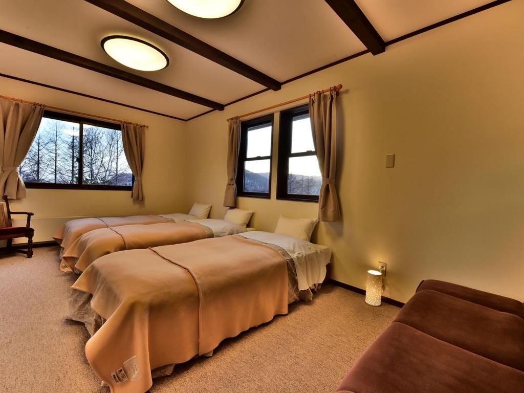 Postel nebo postele na pokoji v ubytování Petit Hotel Kanan