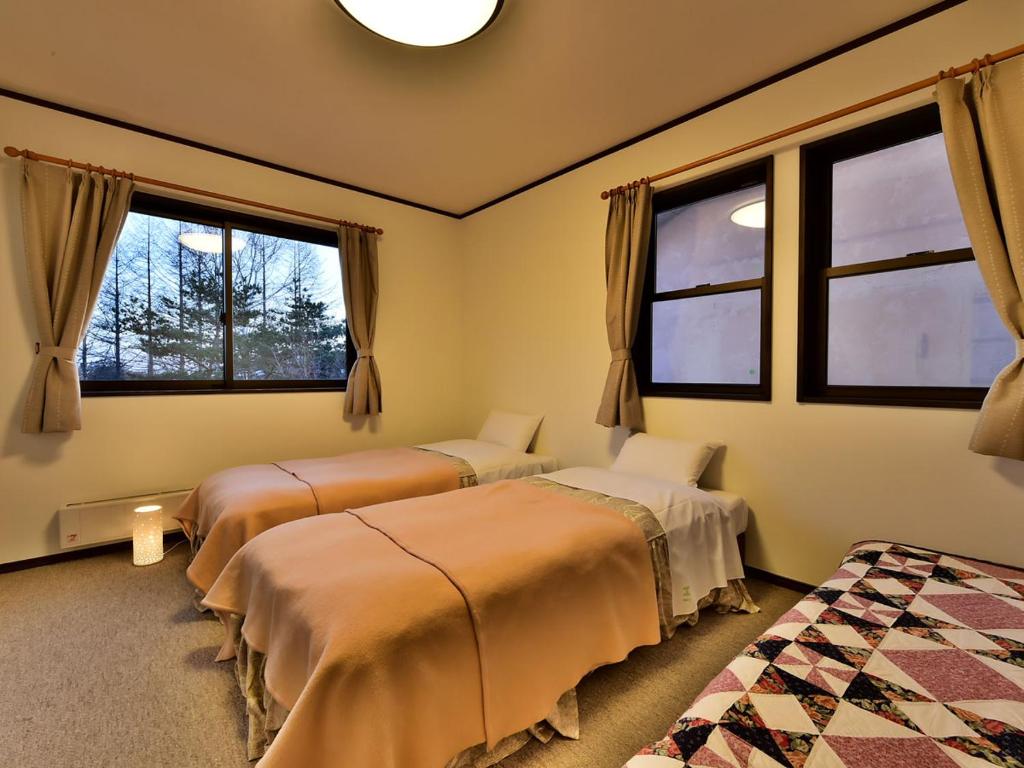 Postel nebo postele na pokoji v ubytování Petit Hotel Kanan