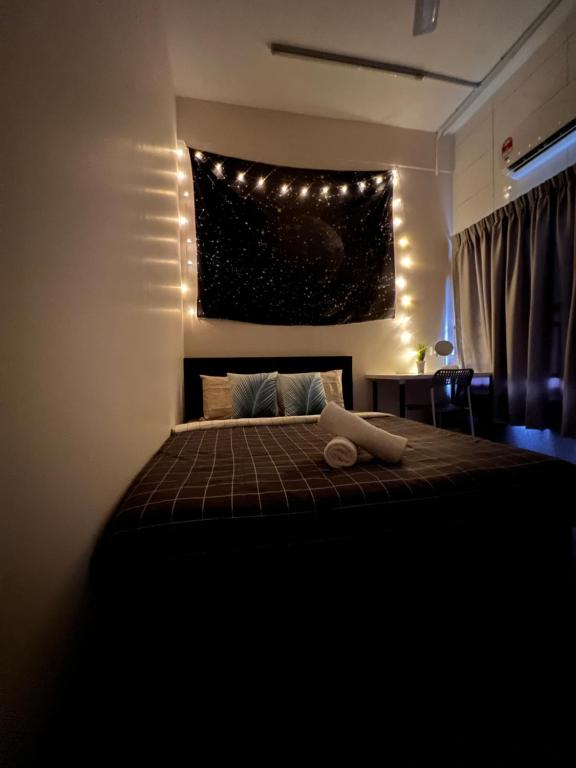 a bedroom with a bed with lights on the wall at Room3#IG theme Bargainous#Shared Bathroom#2pax#2min Kek Lok Si in Ayer Itam