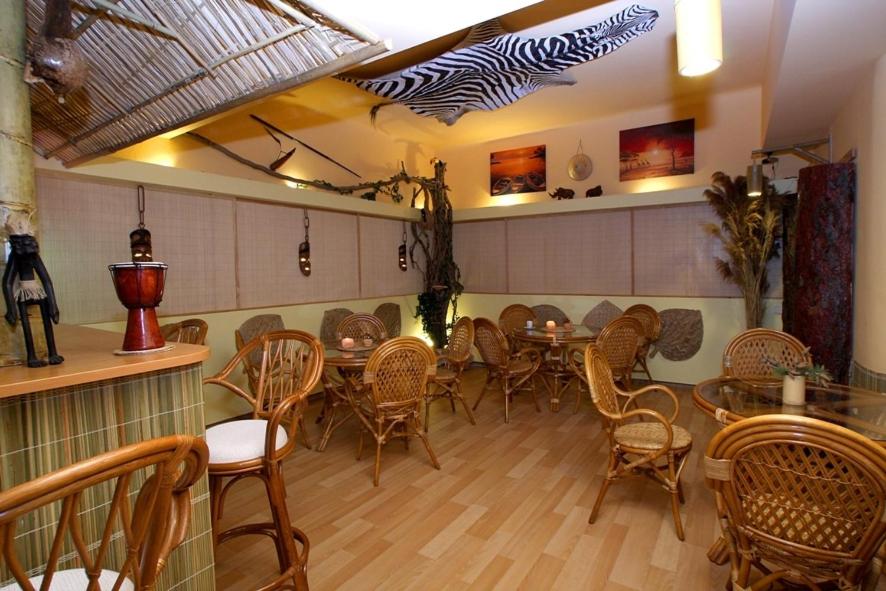 a dining room with tables and chairs in a restaurant at Hotel Amphone in Brno