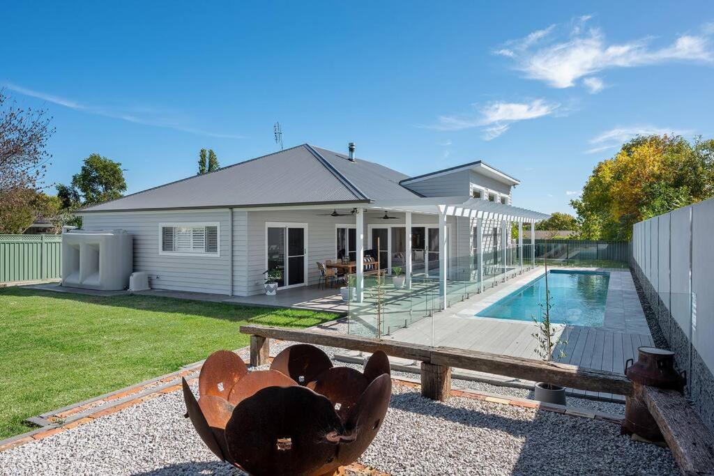 a home with a swimming pool and a house at 'Austin' Mudgee in Mudgee