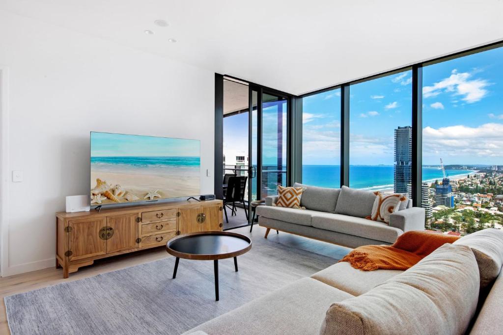 a living room with a couch and a table at Signature Broadbeach Ocean Views Apartment in Gold Coast